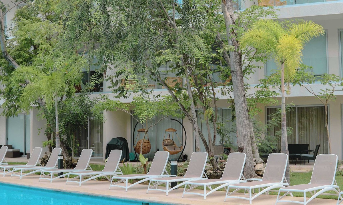 Playacar Condo | Stylish Playacar Condo · Spacious Balcony & Pool