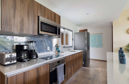 Playacar Condo | Stylish Playacar Condo · Spacious Balcony & Pool